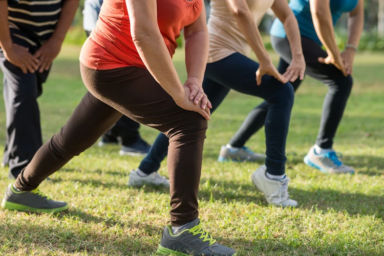 group exercises for elderly people in the park with positive health effects