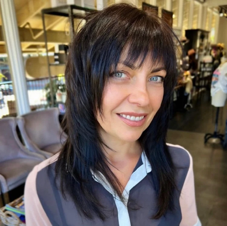 layered wolf haircut with bangs for women over 50
