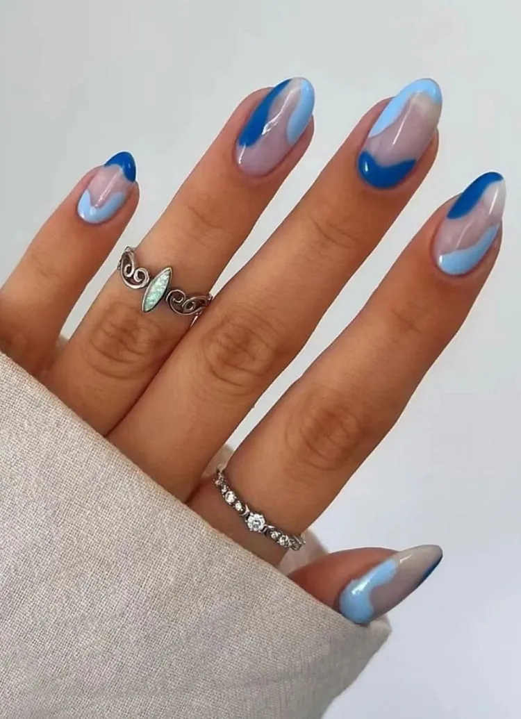 light blue nail design with siwrls