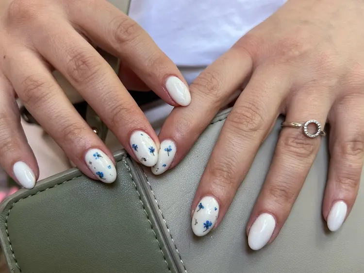 milky white almond nail designs with dried flowers manicure summer trends 2023