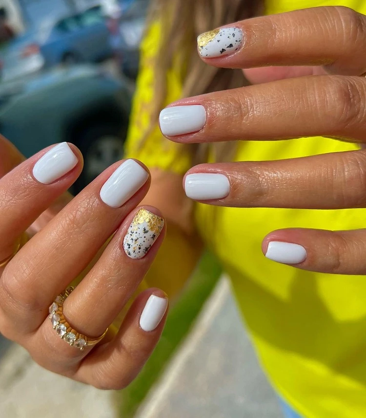 milky white nail design with golden foil summer manicure trends 2023