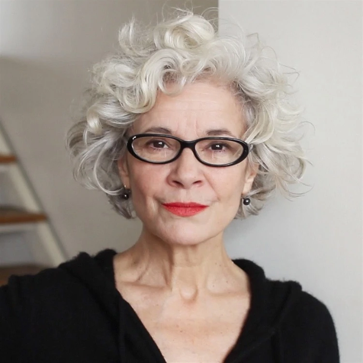 short bob hairstyle for women over 60 with curly hair and glasses