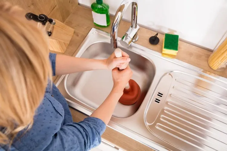 use a plunger to unclog your kitchen sink drains