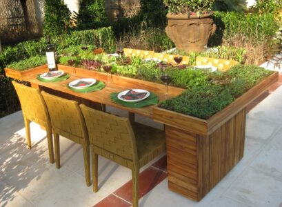 using old furniture in the garden plant flowers on the table's surface