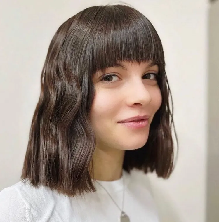 box bob haircut with blunt bangs and waves