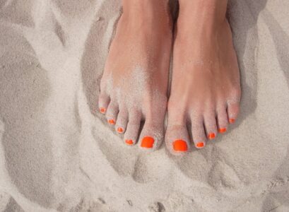 bright orange nail polish popular summer pedicure ideas women over 50