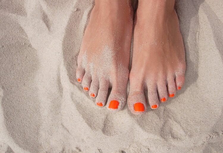 bright orange nail polish popular summer pedicure ideas women over 50