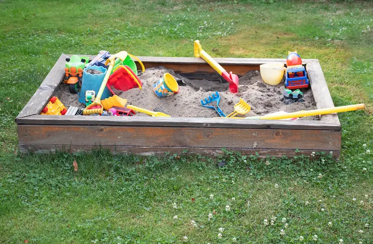 build a sandbox for kids on the lawn and equip with toys