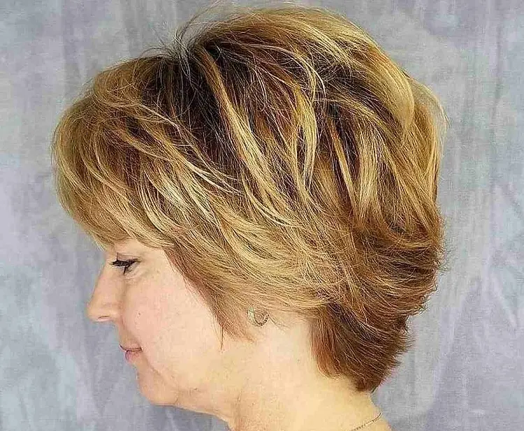 feathered pixie bob haircut for women over 60 with highlights and bangs