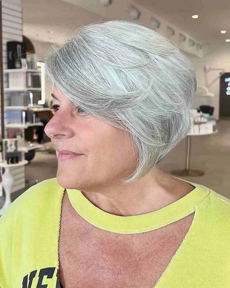 feathered silver bob with side swept fringe for women over 50 layered bobs for fine hair over 50