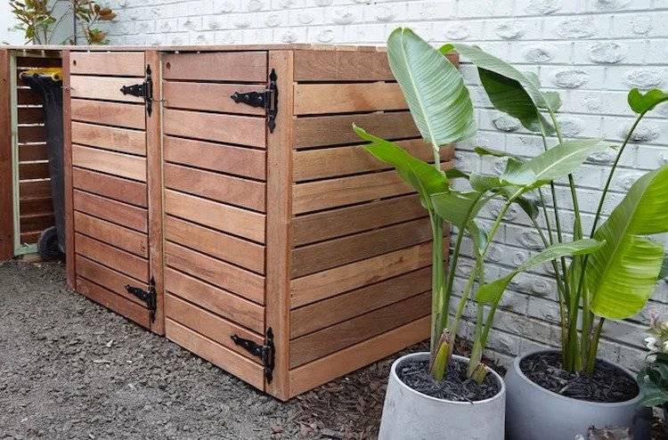 how to conceal trash bins in your garden