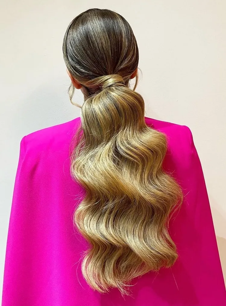 low ponytail with waves wedding guest hairstyle