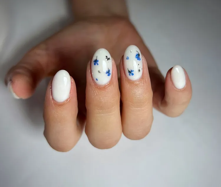 milky white nail design with flowers