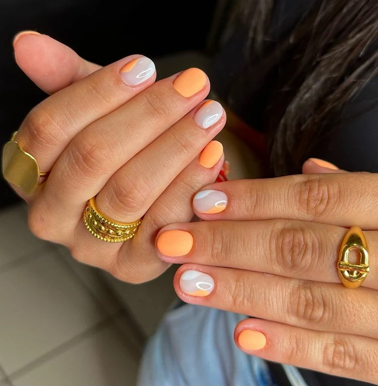 short orange nails with white summer design 2023