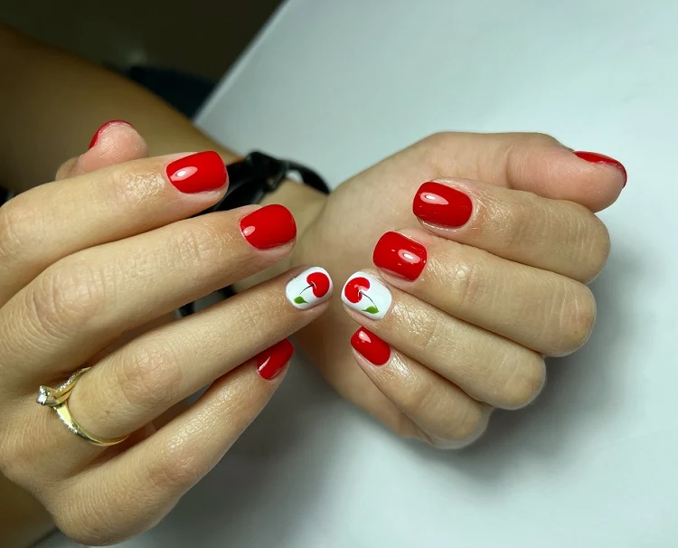 short red summer nails 2023 with a cherry decoration