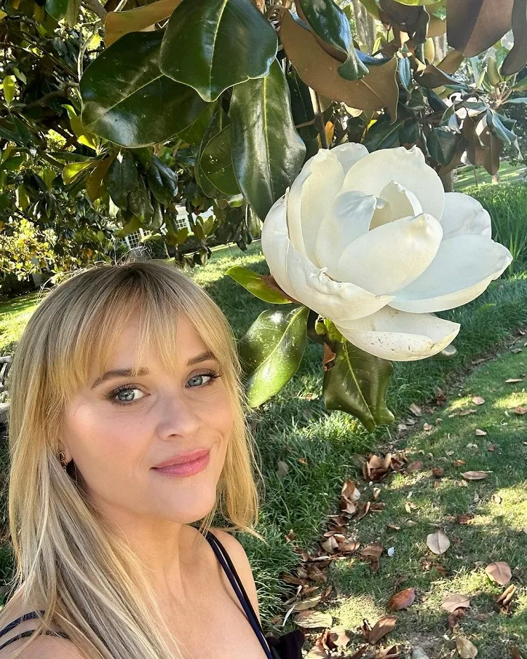 wispy bangs reese witherspoon haircut trends summer 2023 long blond hair