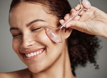 woman face smile skincare rose quartz jade roller