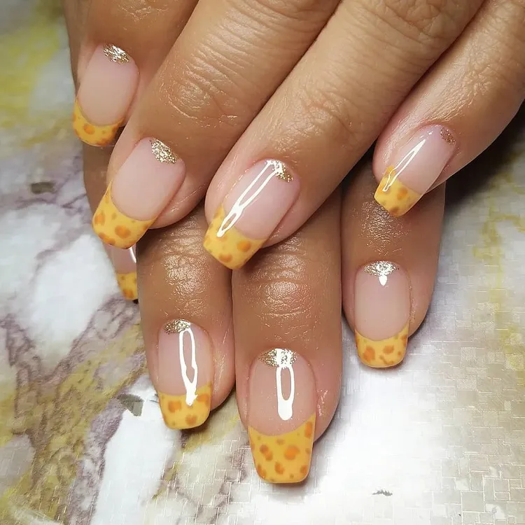 yellow animal print french tips gold glitter half moon manicure long squoval nails