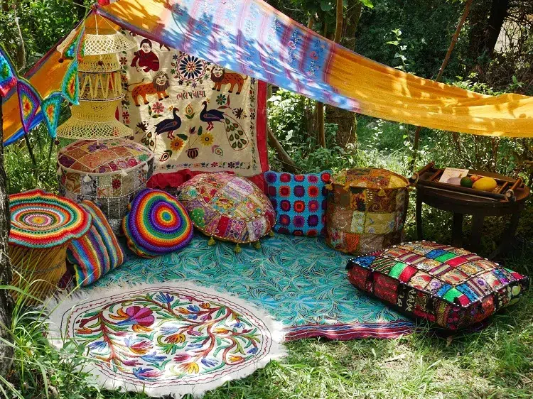 boho yoga hippie corner in the garden with cushions and rugs