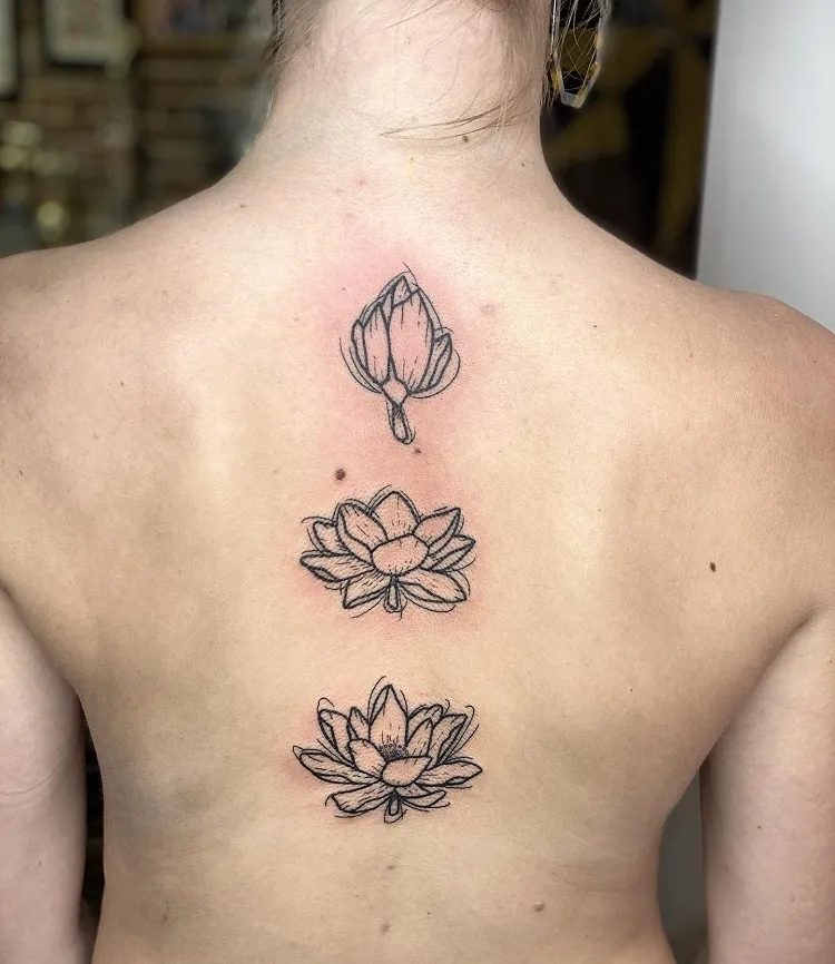 blooming lotus flower stages female spine tattoo design idea