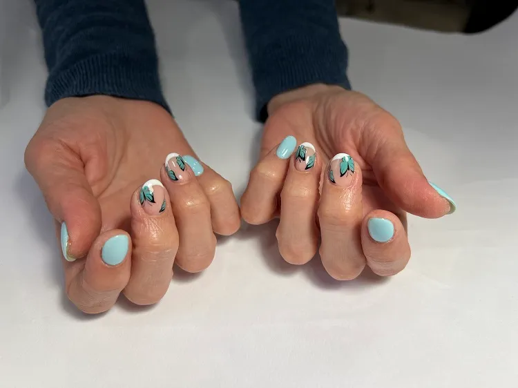 blue french tip nails with butterfly pastel colors