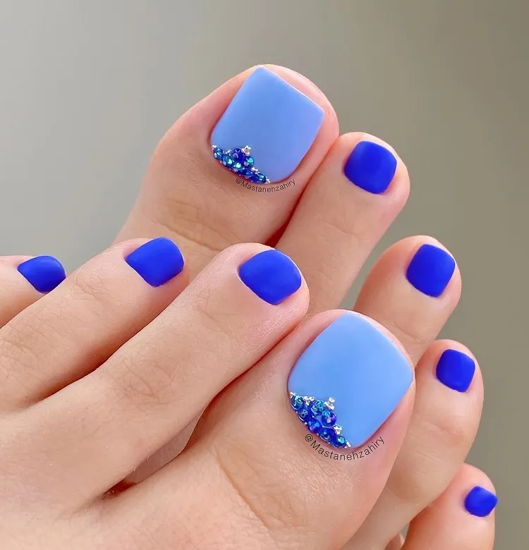 blue matte pedicure with light blue big toe design