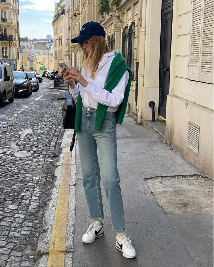 casual fall outfit 2023 straight blue jeans white shirt green sweater nike cortez