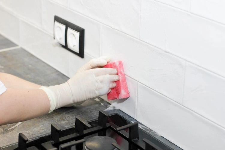 clean greasy kitchen tiles with dishwashing liquid