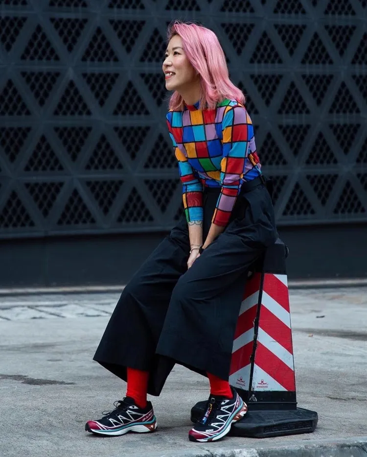 colorful women outfit with salomon shoes fashion trends