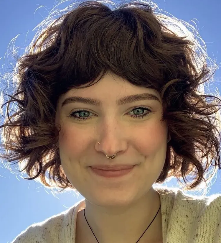 curly french bob with curtain bangs short haircut