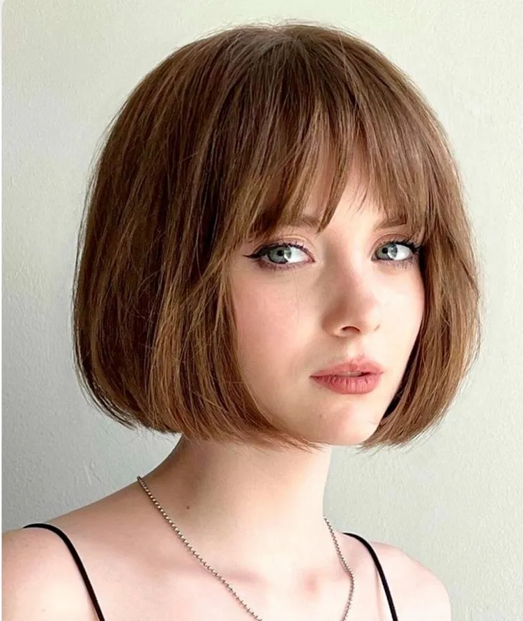 face framing bubble bob with wispy bangs haircut for women