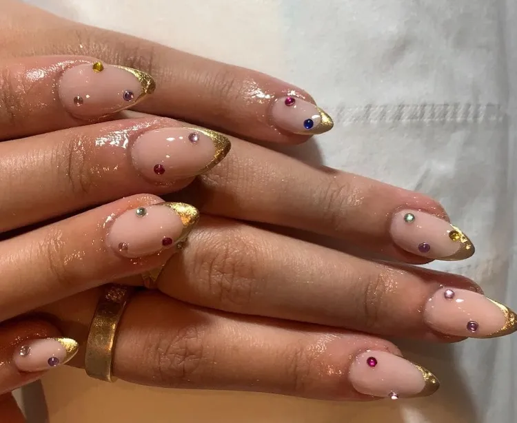 gold french tip nails with rhinestones