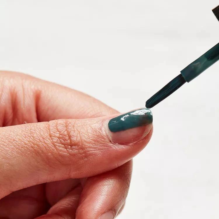 how to repair a broken nail at home applying regular nail polish to complete process
