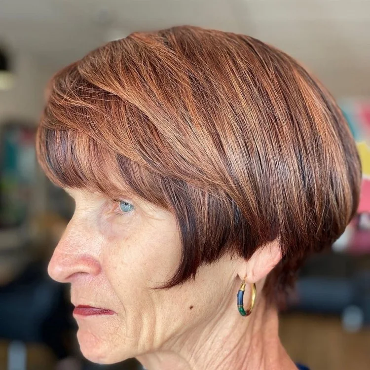 layered bangs hairstyle for women over 60 in honey brown hair colour