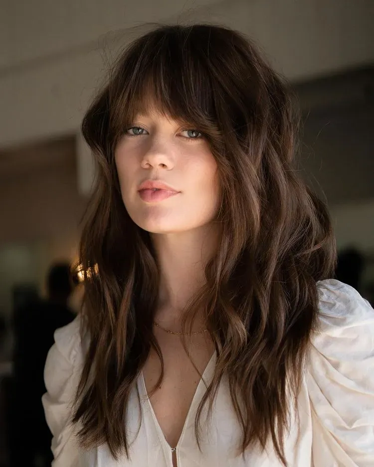 long brown hair with waves and bangs