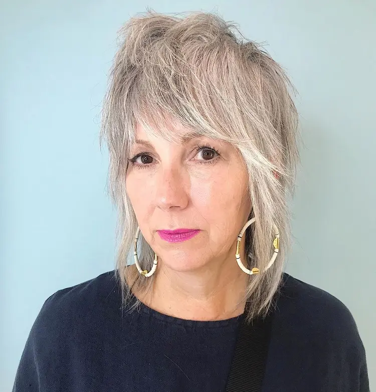 long shaggy bob for women over 50 with bangs 2023