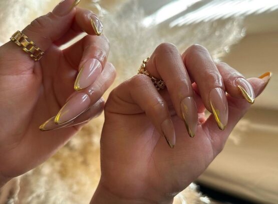 long stiletto gold french tip nails 2023