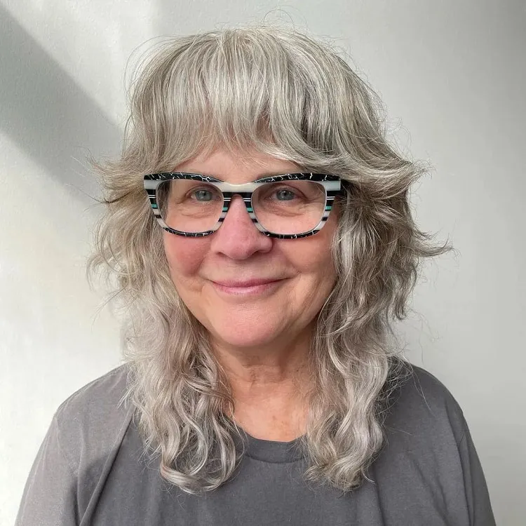 medium shaggy hairstyles for over 60 with glasses wolf cut for women over 60 with bangs
