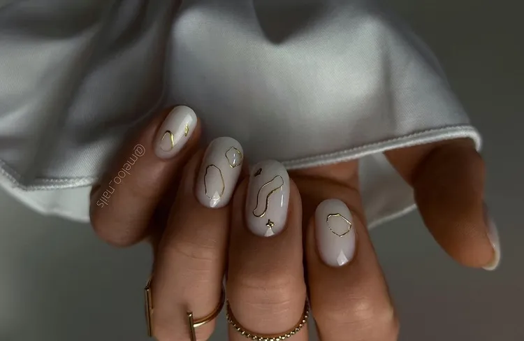 milky white nails russian manicure with simple golden decoration