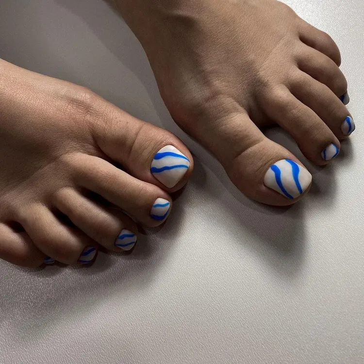 milky white toe nails blue curves abstract creative pedicure design summer 2023