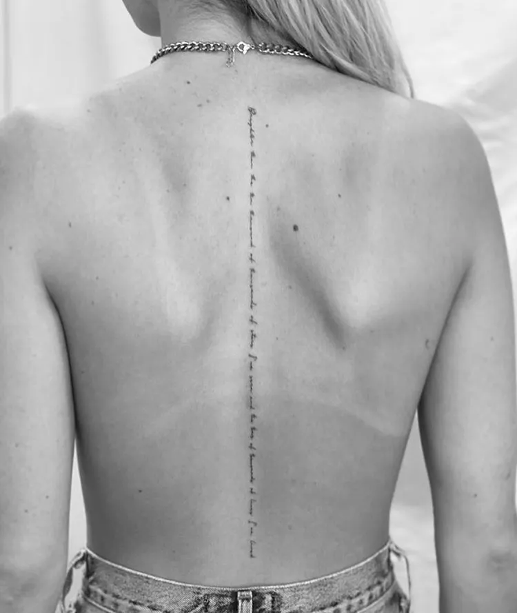 minimalist single needle spine lettering tattoo idea