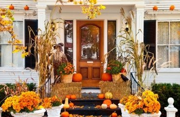modern fall porch decor include pumpkins colored in golden