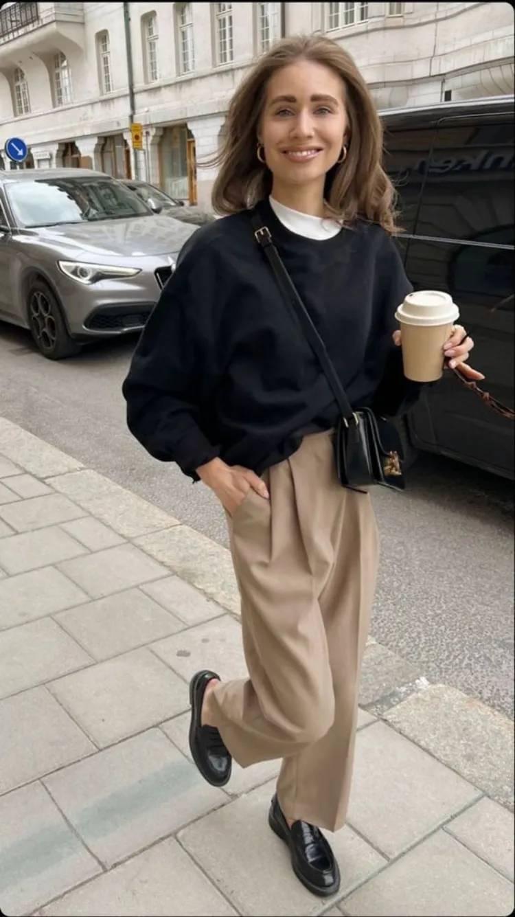 old money fall outfit idea tailored beighe high waisted pants loafers black baggy sweatshirt crossbody bag