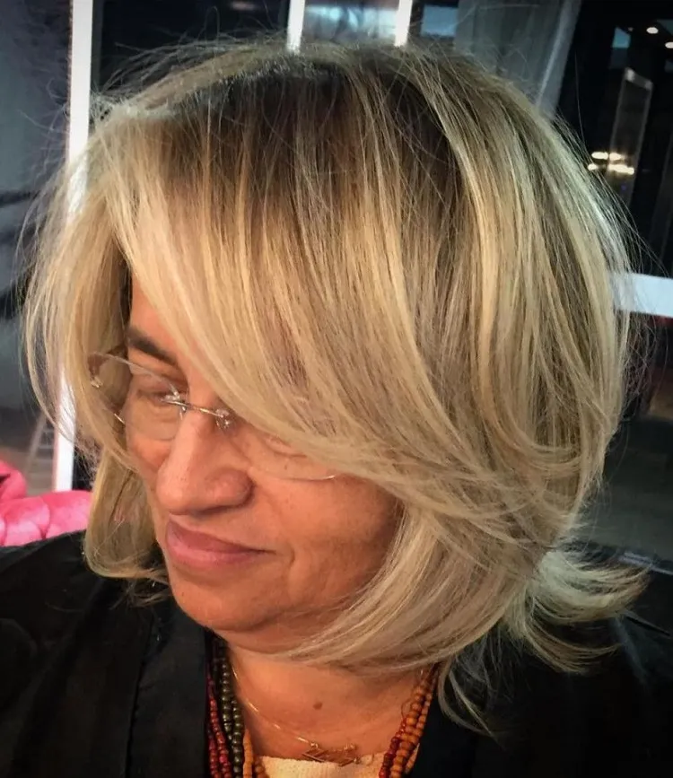 shag bob haircut for women over 50 with side swept bangs