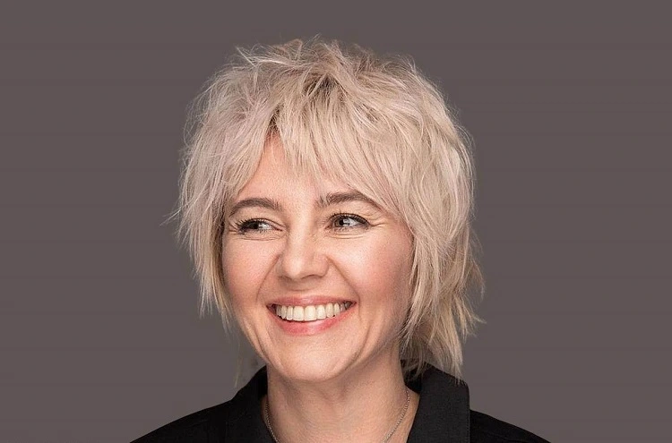 short shaggy bob with face framing bangs for women over 50