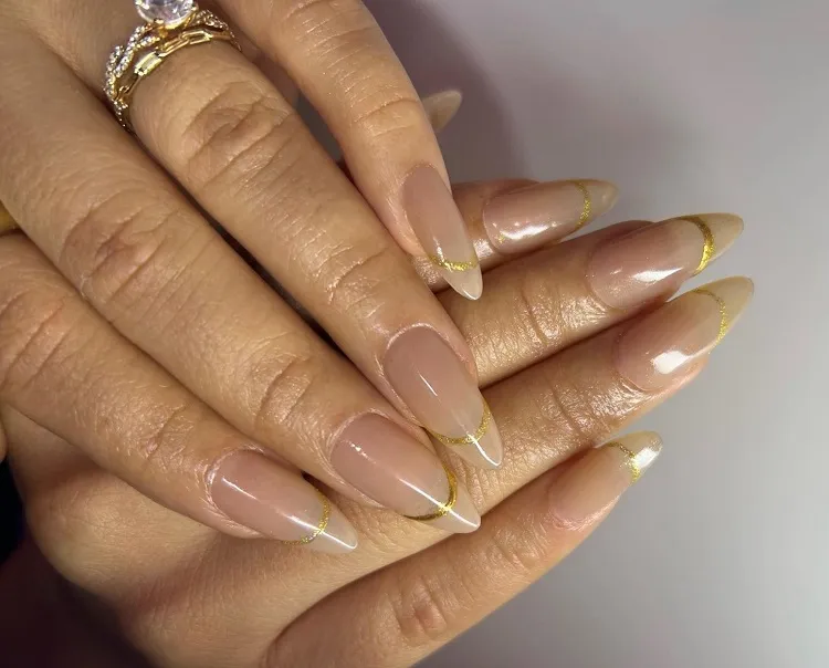 simple gold french manicure with nude base