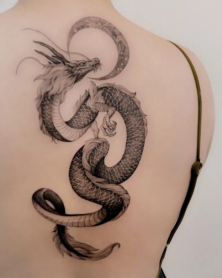 single needle japanese style dragon crescent moon spine tattoo design idea