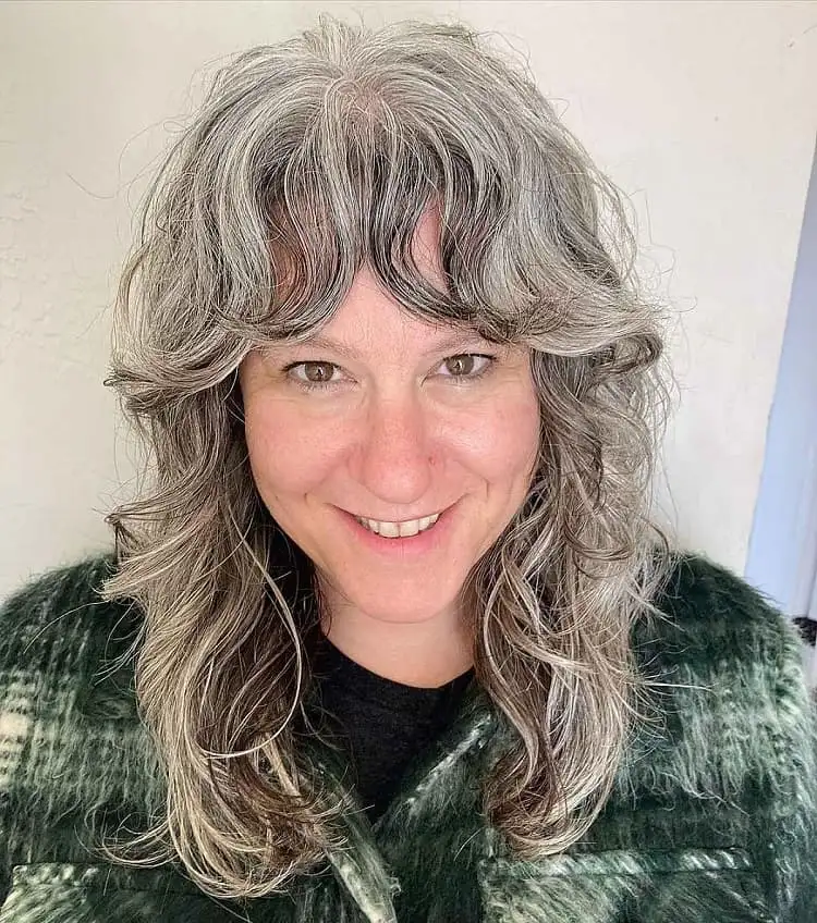 wavy wolf cut for older women with bangs long shaggy hairstyles over 60