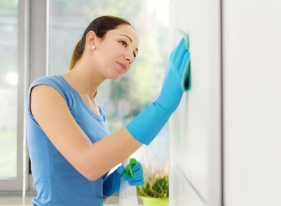 woman cleaning walls at home