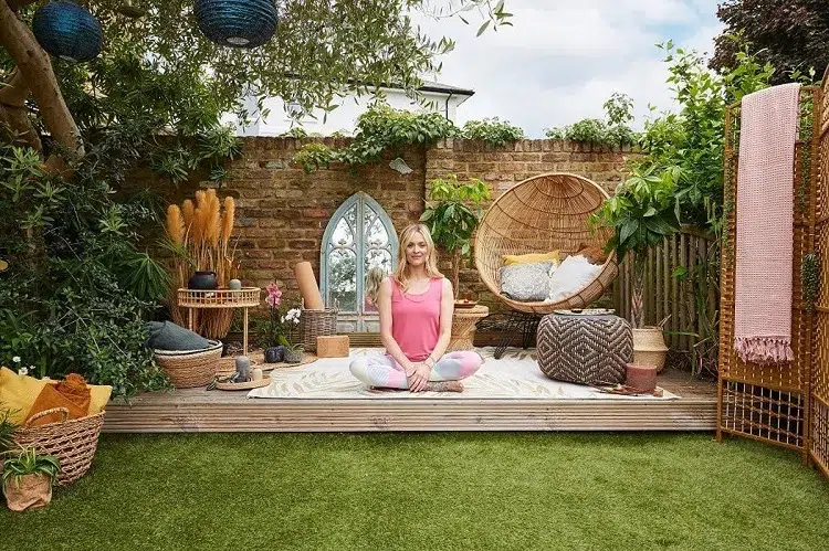 yoga corner in the garden with green plants and comfortable furniture